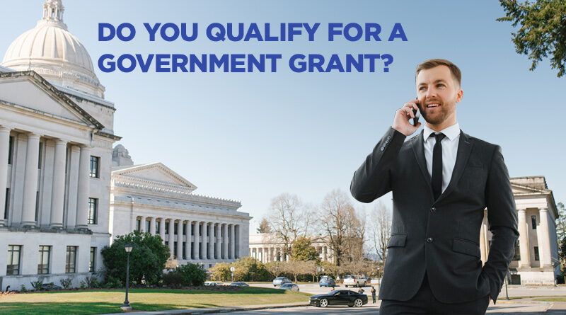 Man on his cell phone standing in front of a government business.