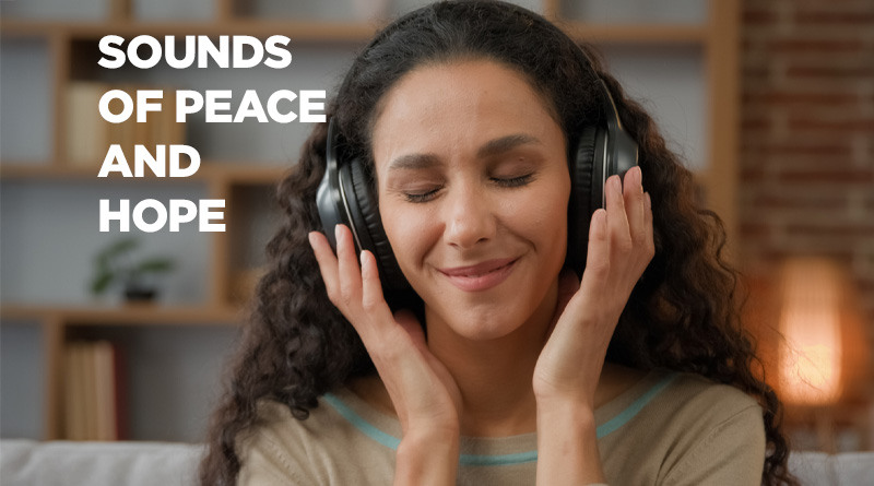 Woman wearing headphones, smiling as she listens to music.